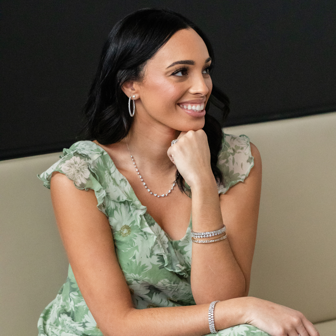 Woman wearing silver necklace, earrings, and bracelet
