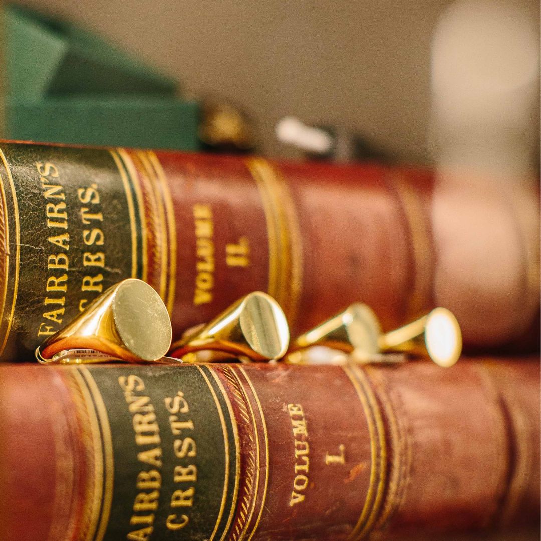 Signet rings sitting on books