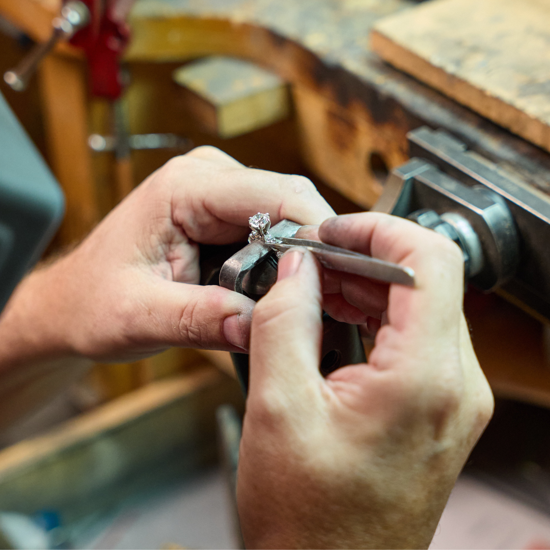 Image of a person setting diamonds into a ring.