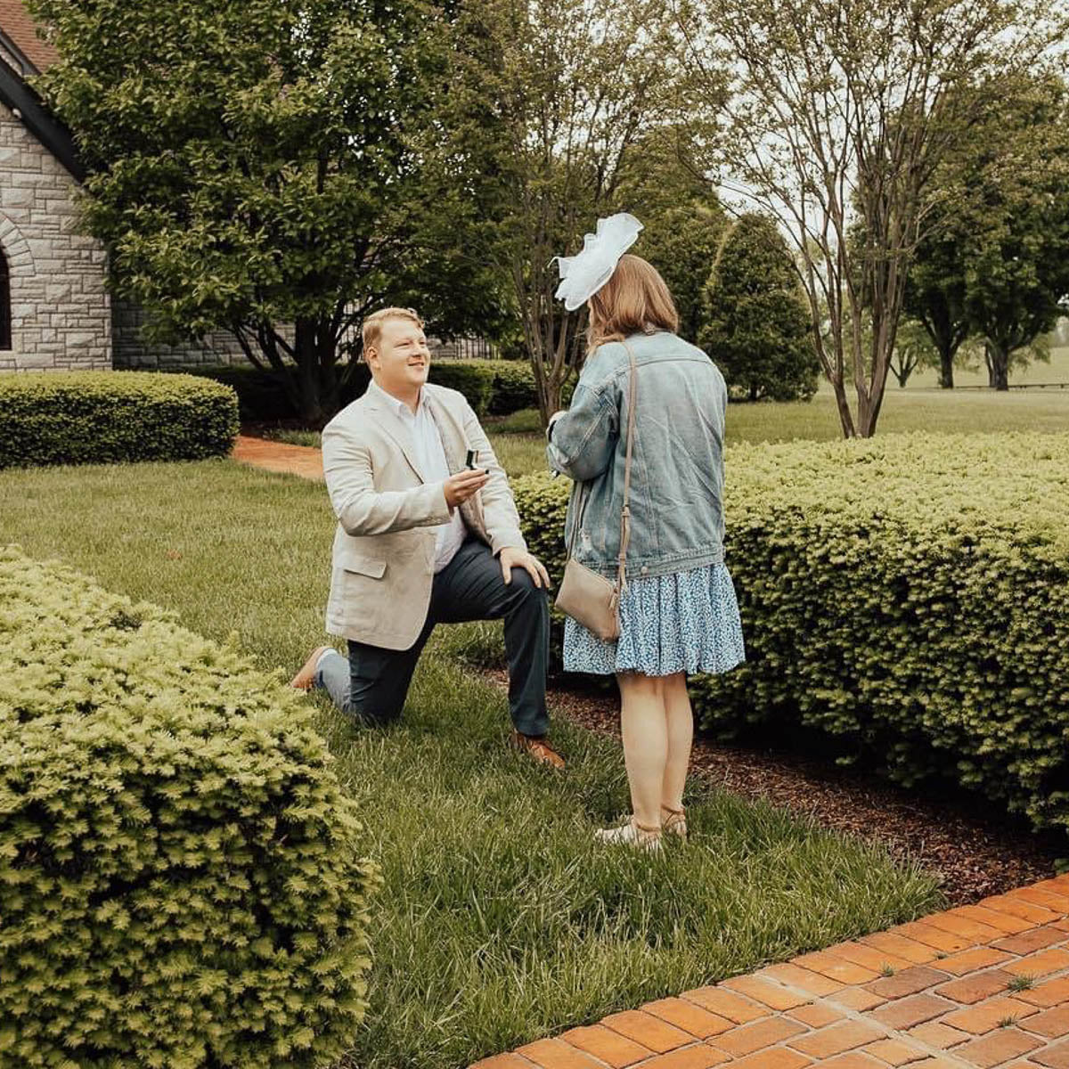 A man on one knee proposing to his girlfriend