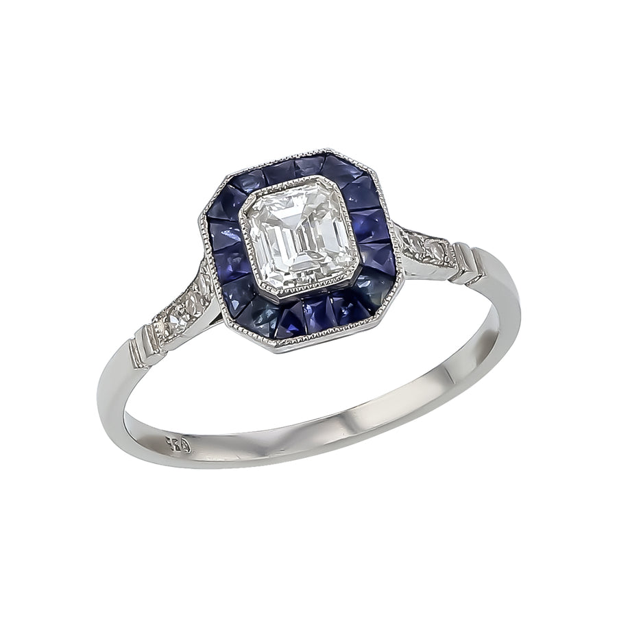 0.55ct Emerald Cut Diamond, 0.70ct Blue Sapphire and 0.16ct Round Diamond Ring in Platinum, size 7